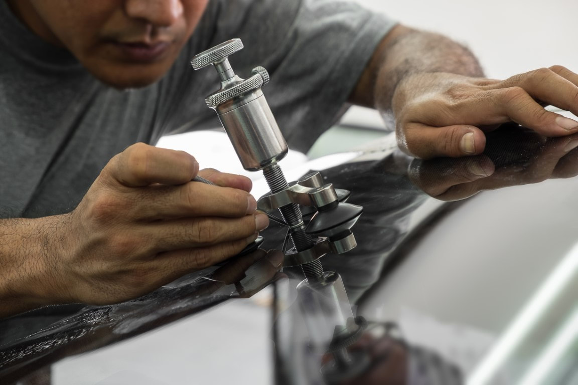 A picture of a man doing glass repair